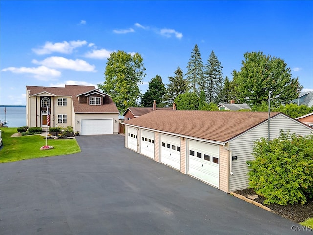 view of front of property with a water view and a garage