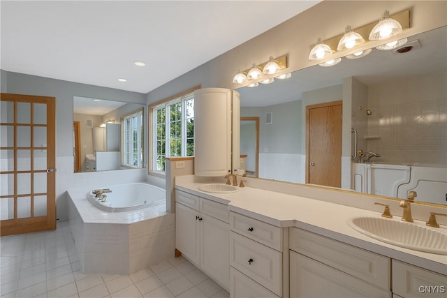 bathroom with plus walk in shower, tile patterned floors, and vanity