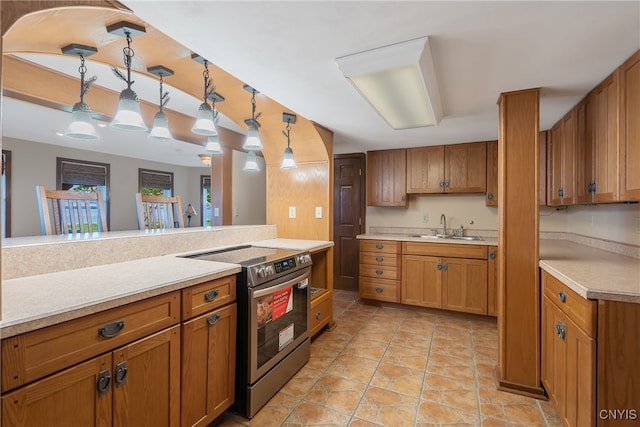 kitchen with pendant lighting, light tile patterned flooring, sink, and stainless steel range with electric cooktop