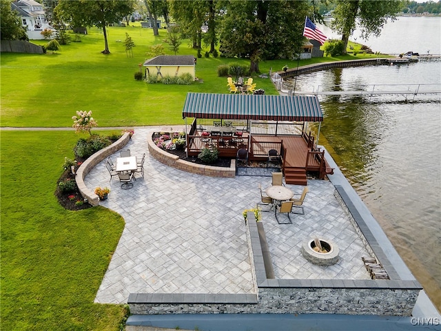 view of home's community with a water view, a yard, a gazebo, a patio, and a fire pit