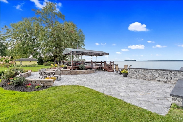 view of yard with a gazebo, a patio, and a water view