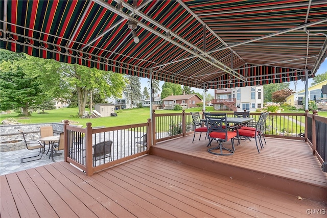 wooden terrace with a lawn