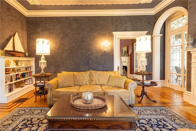 living room with ornamental molding and parquet floors