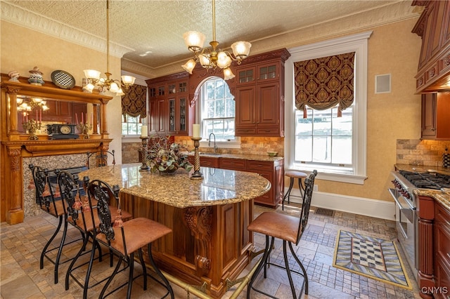 kitchen featuring stainless steel range, a chandelier, tasteful backsplash, and a textured ceiling