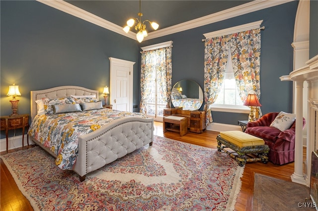 bedroom with wood-type flooring, a notable chandelier, and ornamental molding