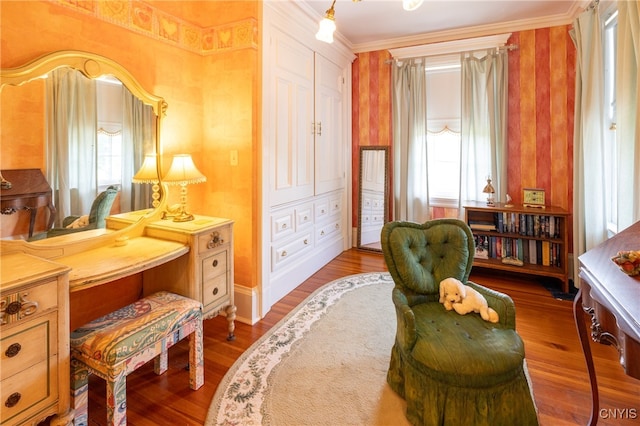 living area featuring ornamental molding and light hardwood / wood-style floors