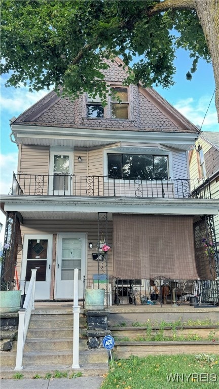 view of front of house with a balcony and covered porch