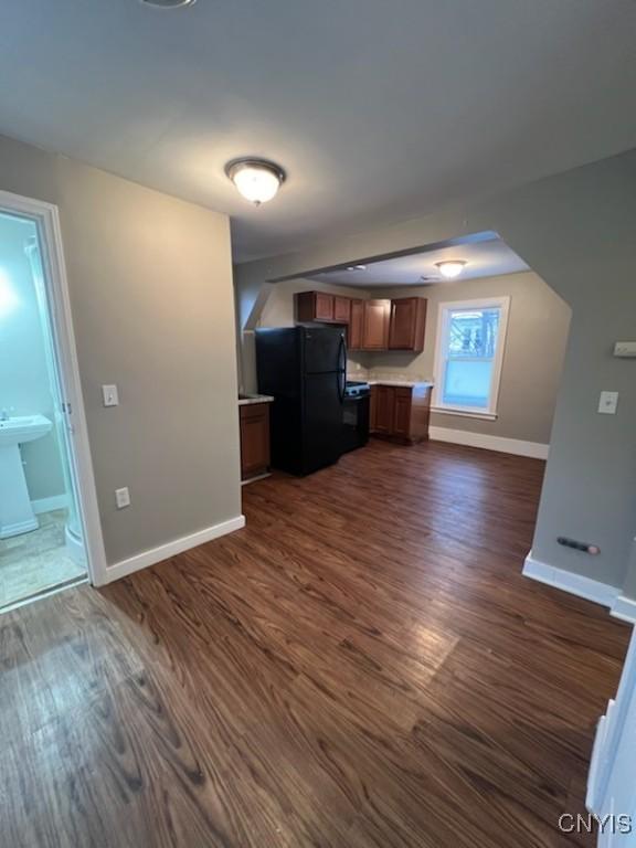 unfurnished living room featuring dark hardwood / wood-style floors