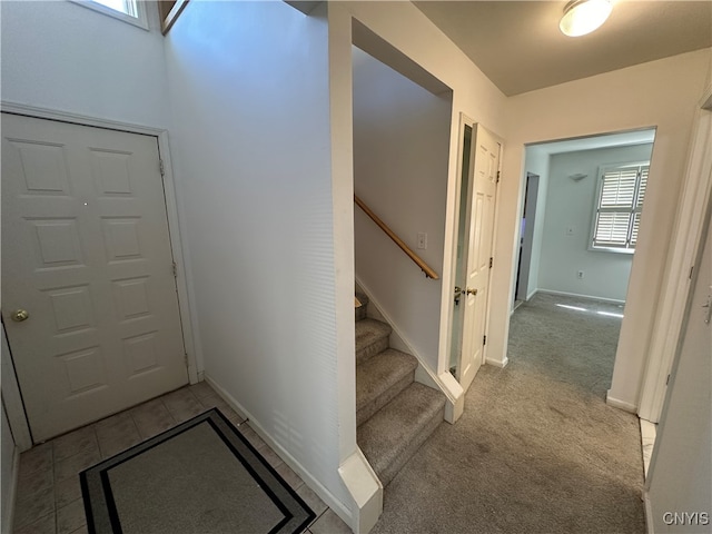 foyer with light colored carpet