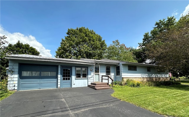 ranch-style home featuring a garage and a front yard