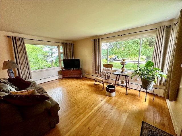 living room with baseboard heating and hardwood / wood-style flooring