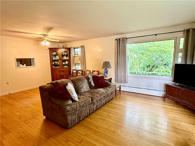 living room with baseboard heating, ceiling fan, and light hardwood / wood-style floors