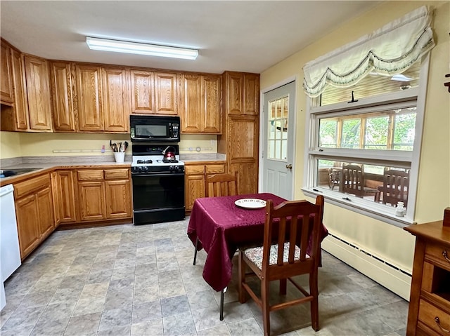 kitchen featuring sink, a baseboard radiator, and black appliances