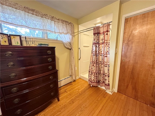 interior space with baseboard heating and light wood-type flooring