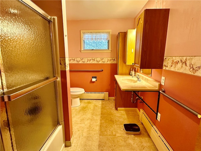 full bathroom with shower / bath combination with glass door, toilet, baseboard heating, and sink