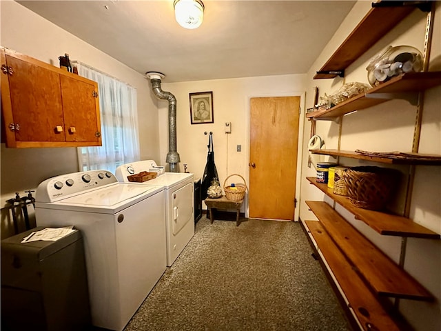 laundry room featuring washing machine and clothes dryer and cabinets