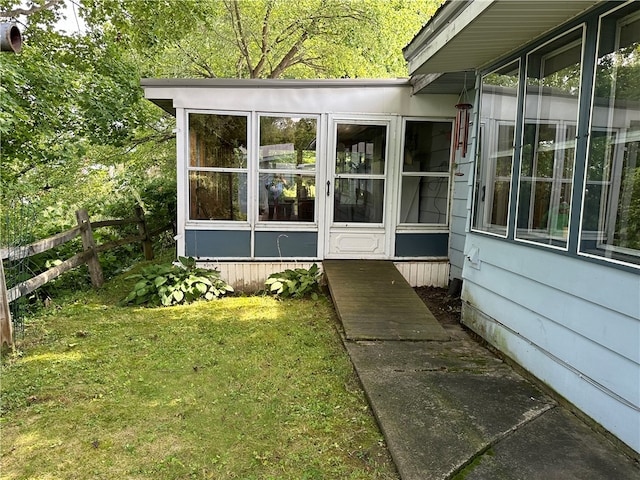 doorway to property featuring a lawn