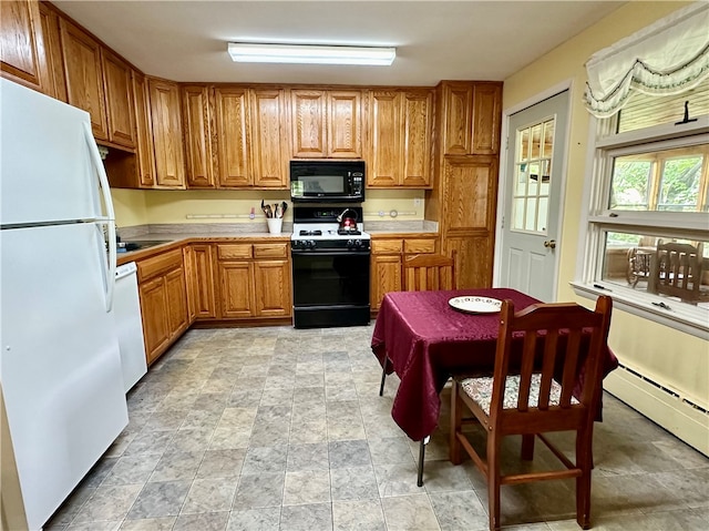 kitchen with baseboard heating and black appliances