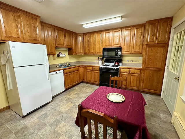 kitchen with white appliances, a baseboard radiator, and sink