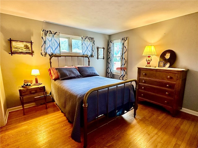 bedroom with hardwood / wood-style flooring