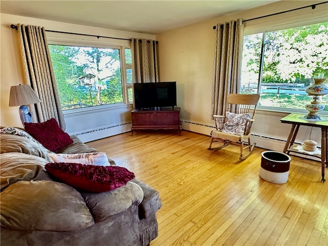 living room with hardwood / wood-style floors and a baseboard radiator