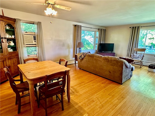 dining area with cooling unit, ceiling fan, light hardwood / wood-style floors, and a baseboard heating unit