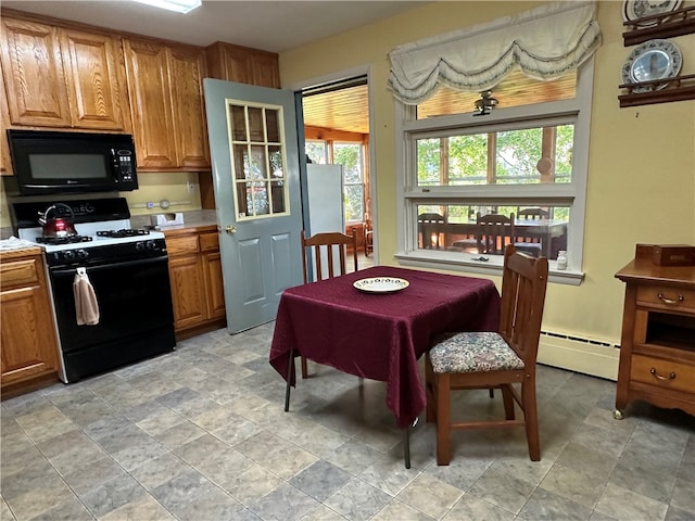 kitchen with baseboard heating and black appliances