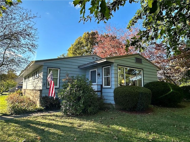 view of home's exterior with a yard