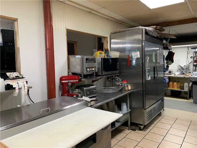 452 Main, Independence, NY 14897 - kitchen with stainless steel microwave, fridge, light tile patterned floors, and a paneled ceiling