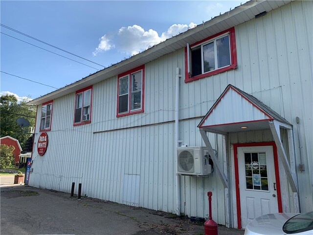 view of side of home featuring ac unit and central AC unit