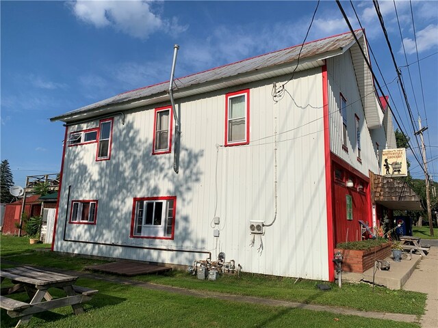 view of property exterior with a yard