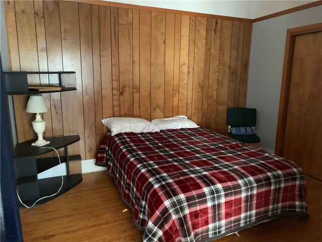 bedroom with wood walls