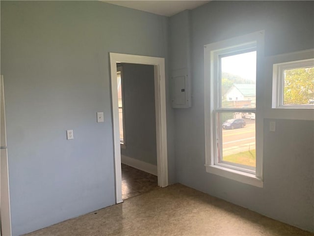 carpeted empty room featuring electric panel