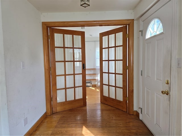 entryway with light hardwood / wood-style flooring and french doors