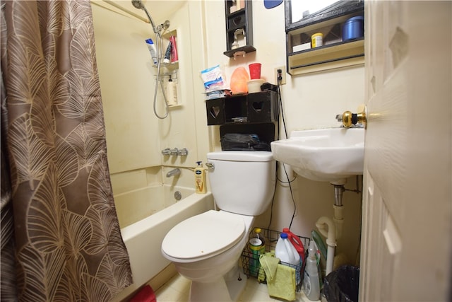 full bathroom featuring toilet, sink, tile patterned floors, and shower / bathtub combination with curtain