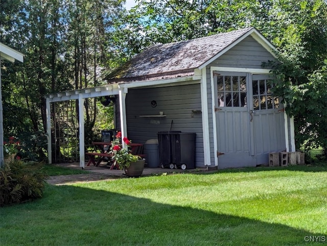 view of outbuilding with a yard