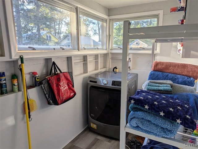 laundry area featuring separate washer and dryer and hardwood / wood-style flooring