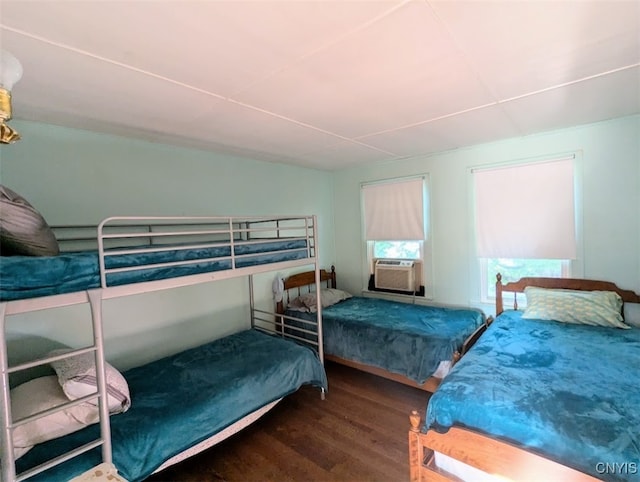 bedroom with dark wood-type flooring and cooling unit