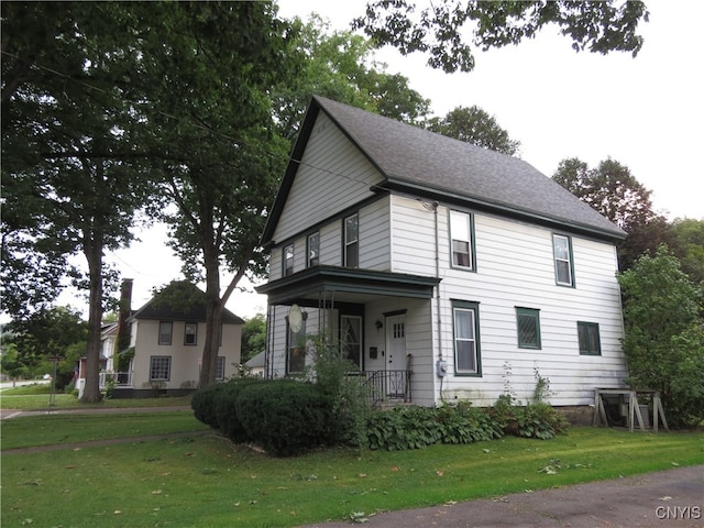 view of front of house with a front yard and a porch