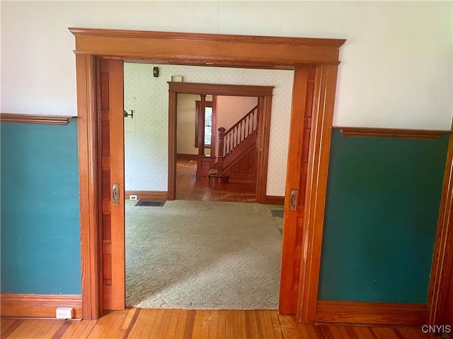 hall with wood-type flooring