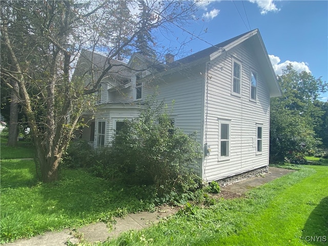 view of side of property with a yard