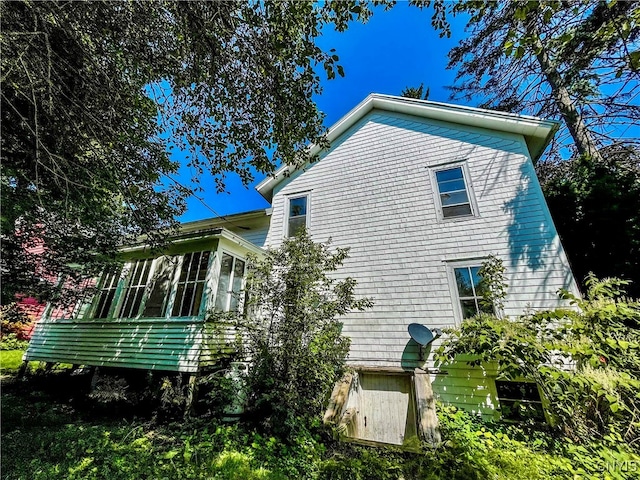 view of side of property with a sunroom