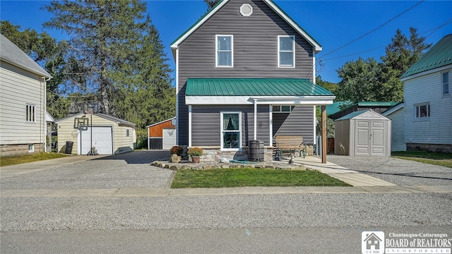 view of front of house featuring a garage and a storage unit