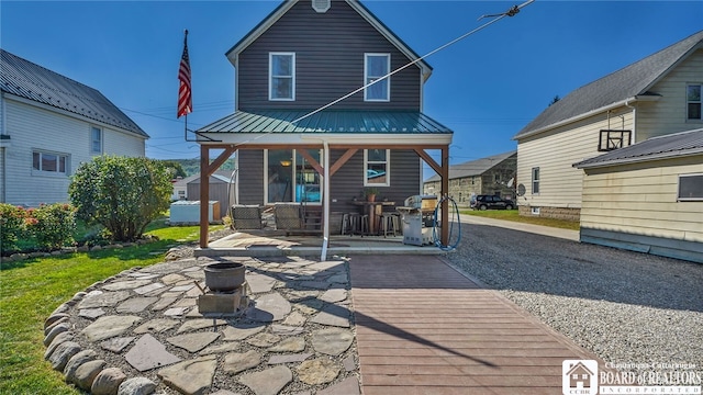 rear view of house featuring a patio