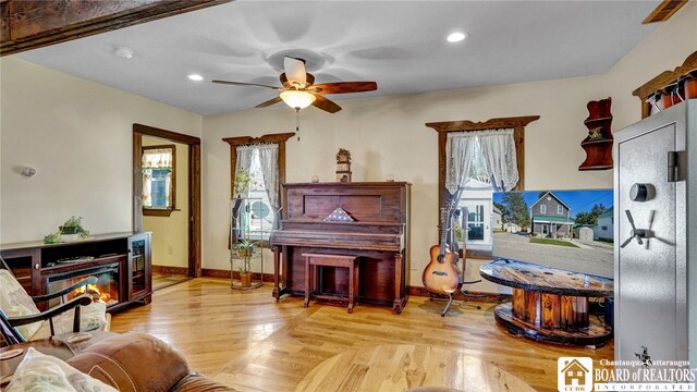 sitting room with light hardwood / wood-style flooring, ceiling fan, and a healthy amount of sunlight