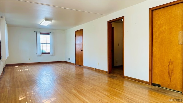 spare room featuring light hardwood / wood-style flooring