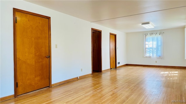 unfurnished room with light wood-type flooring