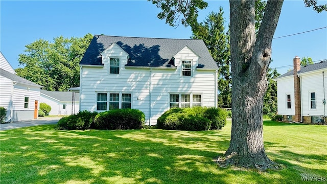 new england style home featuring a front yard