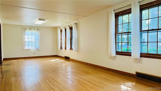 unfurnished room with light wood-type flooring