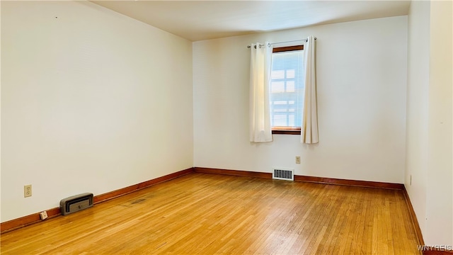 spare room featuring light wood-type flooring